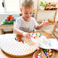 Boy  playing with natural wooden pegboard. Toddler playing with educational toy. Boy playing in daycare centre. Natural Wooden Rainbow Pegboards. Wooden Educational & Sensory Play Toy. Wooden Pegs, Wooden Peg Board. Australian Owned Company - Little Pegz